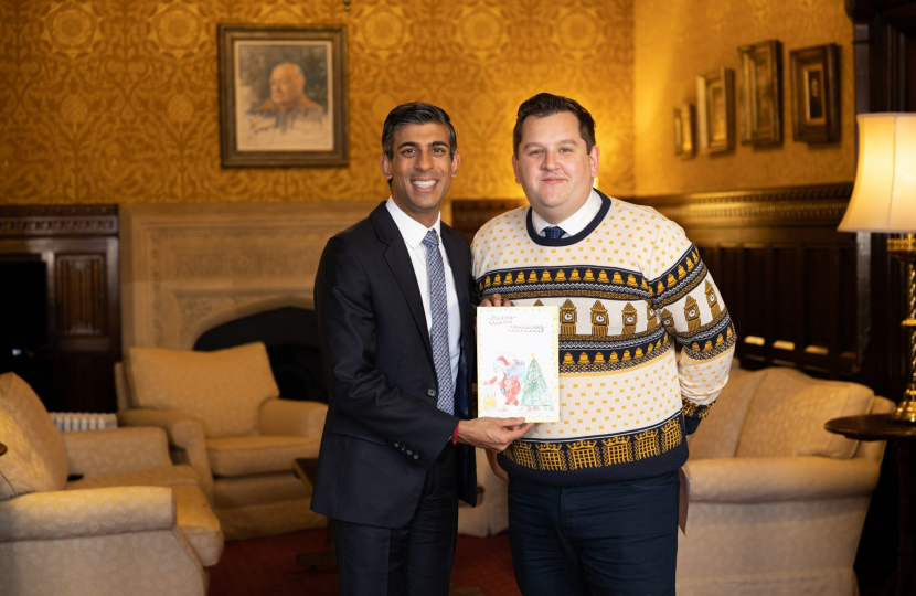 Louie showing the Prime Minister the winning Christmas card design