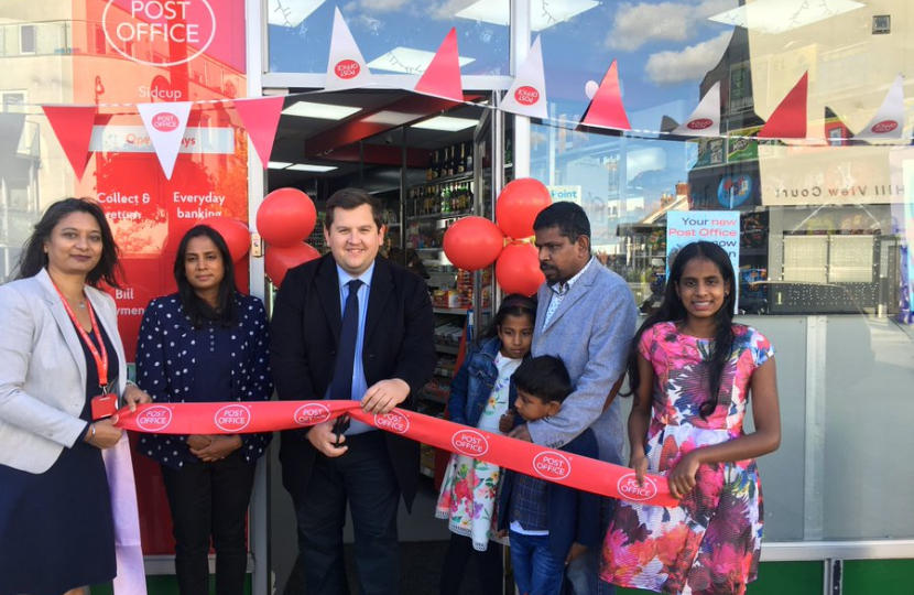 Louie cutting ribbon to open new Post Office